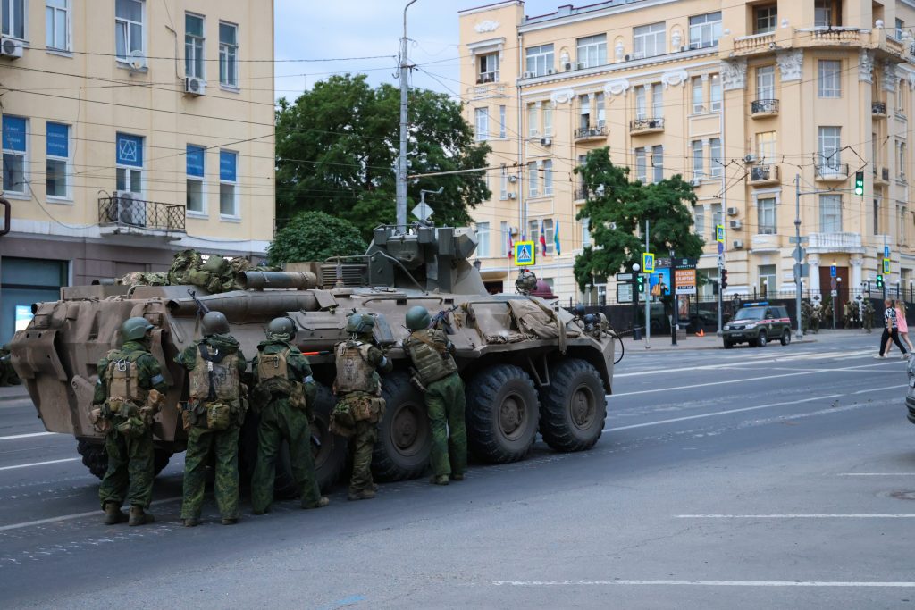 Wagner fighters take position behind an armored vehicle outside the Southern Military District headquarters on June 24, 2023. 