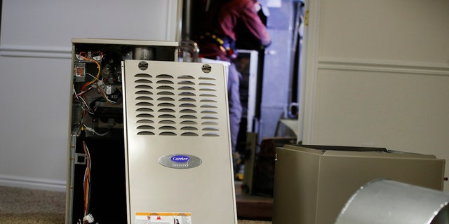 A new Carrier natural gas furnace at a residential home in Spanish Fork, Utah, U.S., on Tuesday, Oct. 19, 2021. Staying warm this winter in the country will come at a higher cost this year along with most other consumer expenses as heating oil, natural gas and other fuels surge in price, reports Newsweek. Photographer: George Frey/Bloomberg