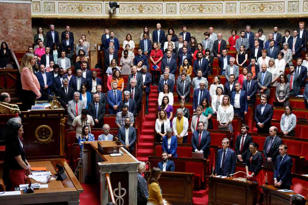 Members of French Parliament stand for a moment of silence after a knife attack in Annecy on June 8, 2023. 