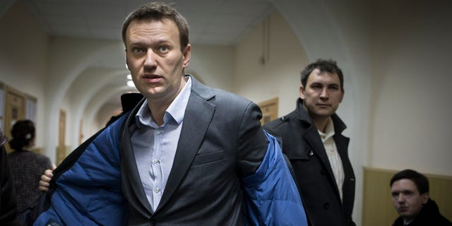 Alexei Navalny taking off his coat