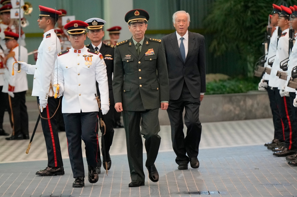 Chinese Defense Minister Gen. Li Shangfu, center, inspects the honor guard with Singapore Defense Minister Ng Eng Hen, right, during his official visit to the defense ministry in Singapore, on June 1, 2023.