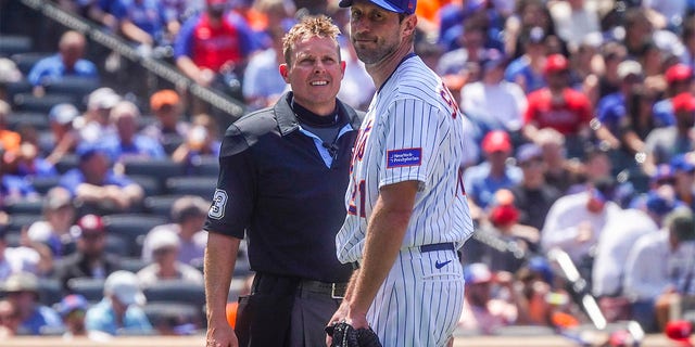 Max Scherzer speaks with the home plate umpire