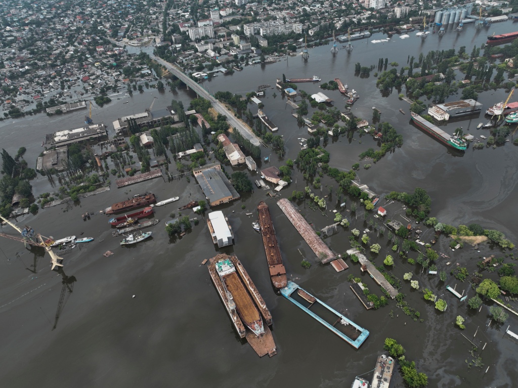 Streets and trade port are seen underwater and polluted by oil in Kherson.