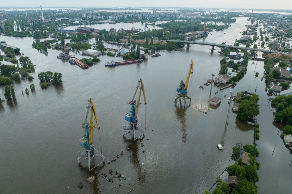 Streets and trade port are seen underwater and polluted by oil in the flooded Kherson.