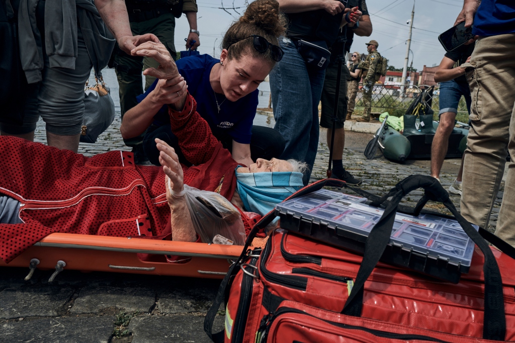 Emergency workers evacuate an elderly resident from a flooded neighborhood in Kherson.