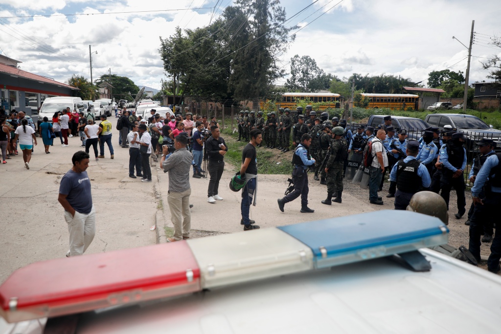 Onlookers are spotted at the entrance of the prison after the deadly riot that killed at least 41 women in Tamara on June 20, 2023. 