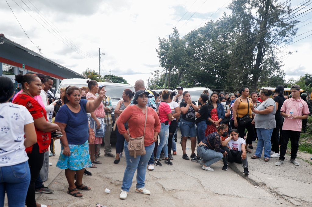 Family members wait outside the entrance of the women's prison in Tamara on June 20, 2023. 