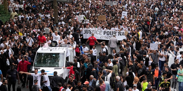 Protesters marching and holding signs