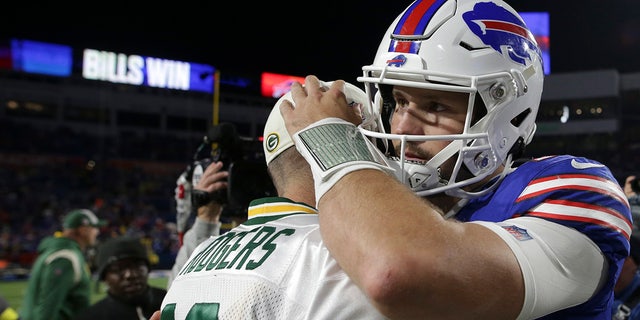 Josh Allen hugs Aaron Rodgers after a game