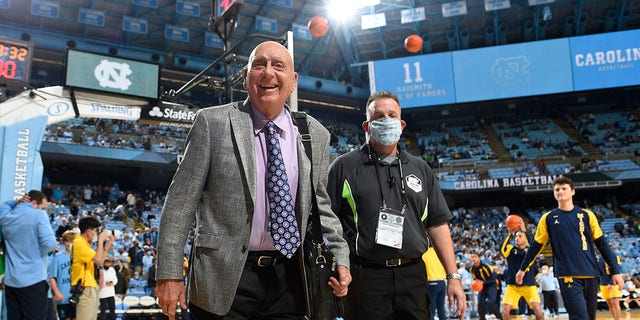 Dick Vitale walks on the basketball court before a game