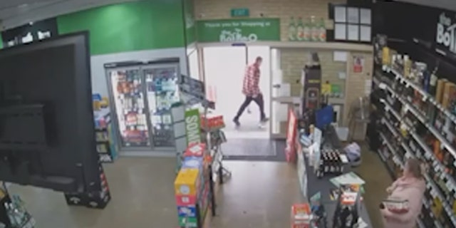 Man exits the store after cashier opens the door