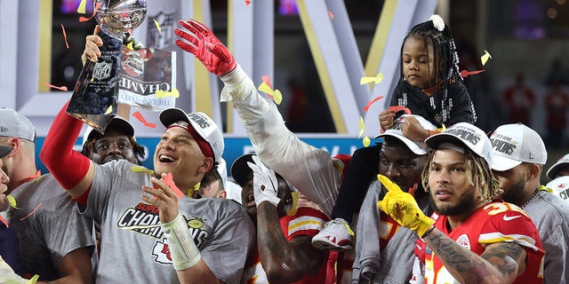 Patrick Mahomes holds trophy