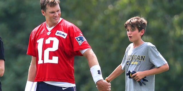 Tom Brady walks off the field with son, Jack