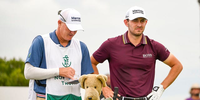 Patrick Cantlay consults with caddie Joe LaCava