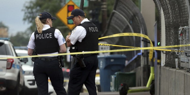 Chicago police stand near a crime scene