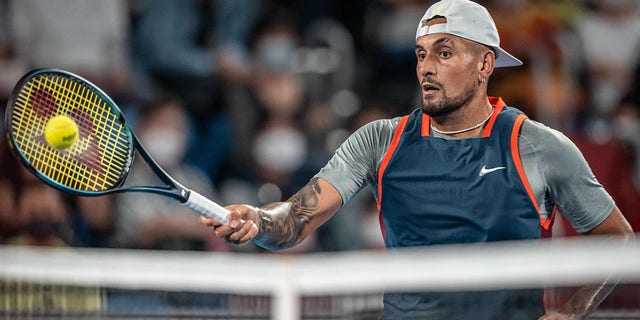 Nick Kyrgios returns a ball against Tseng Chun-hsin