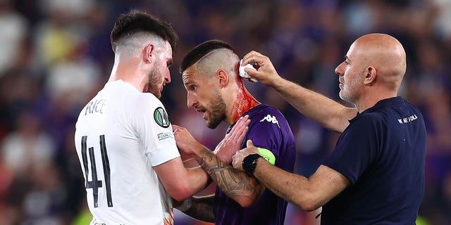 Cristiano Biraghi gets checked for a head wound