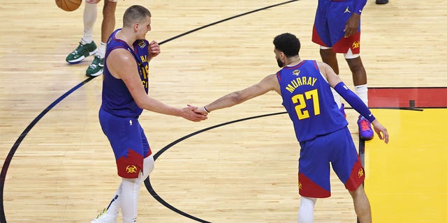 Nikola Jokic and Jamal Murray high five