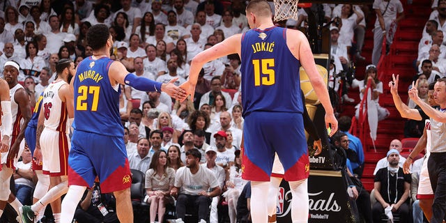 Jamal Murray high fives Nikola Jokic