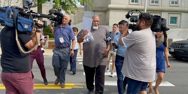 Cedric Lodge walking outside court