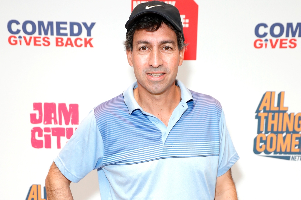 Series creator Steve Dildarian. He's posing in a blue, open-neck polo shirt and wearing a black baseball cap.