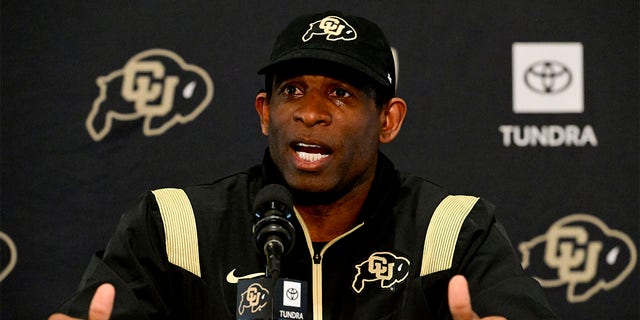 Deion Sanders speaks to the media