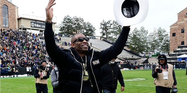 Deion Sanders waves to the Colorado crowd