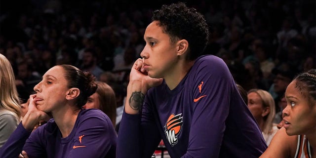 Brittney Griner with Diana Taurasi sit on bench