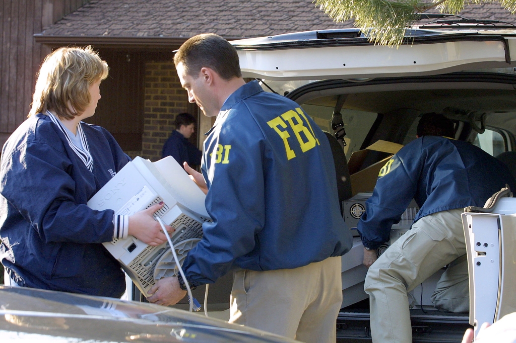FBI agents remove evidence from the home of FBI agent Robert Philip Hanssen February 20, 2001 in Vienna, Va. 