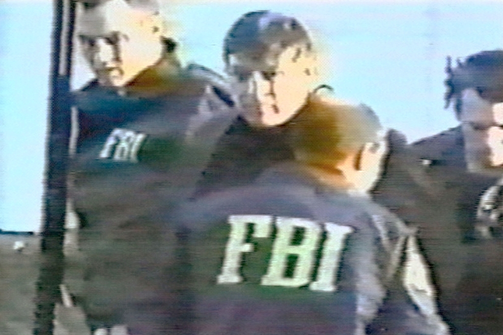 FBI agents arrest counterintelligence agent Robert Hanssen (C) near his home February 18, 2001