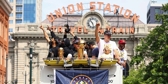 Jamal Murray and Nikola Jokic celebrate at the championship parade