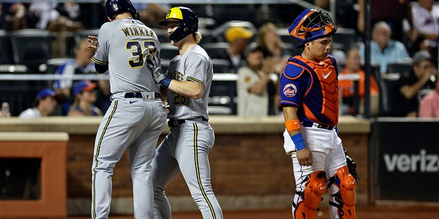 Joey Wiemer is congratulated by Jesse Winker