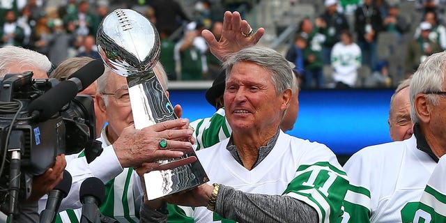 Jim Turner gets handed a Super Bowl trophy