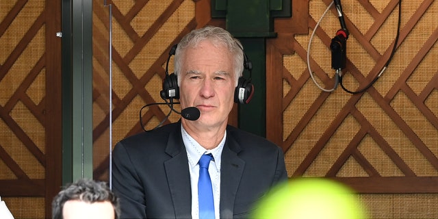 John McEnroe commentates during Wimbledon