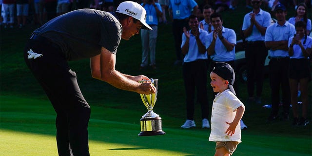 Keegan Bradley celebrates with his son