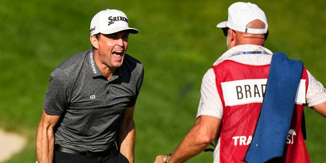 Keegan Bradley celebrates with caddy