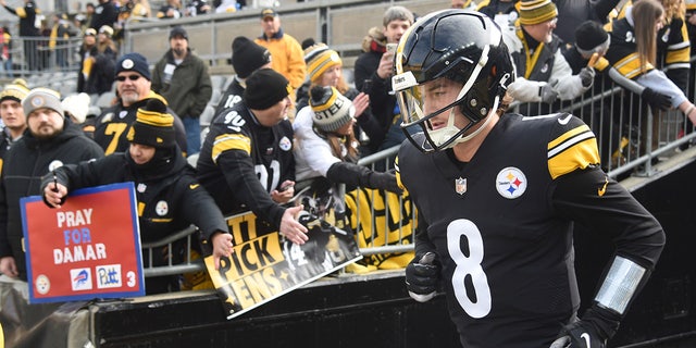 Kenny Pickett runs onto the field