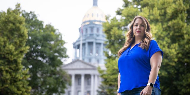 303 Creative owner Lorie Smith stands in front of the Colorado State Capitol.