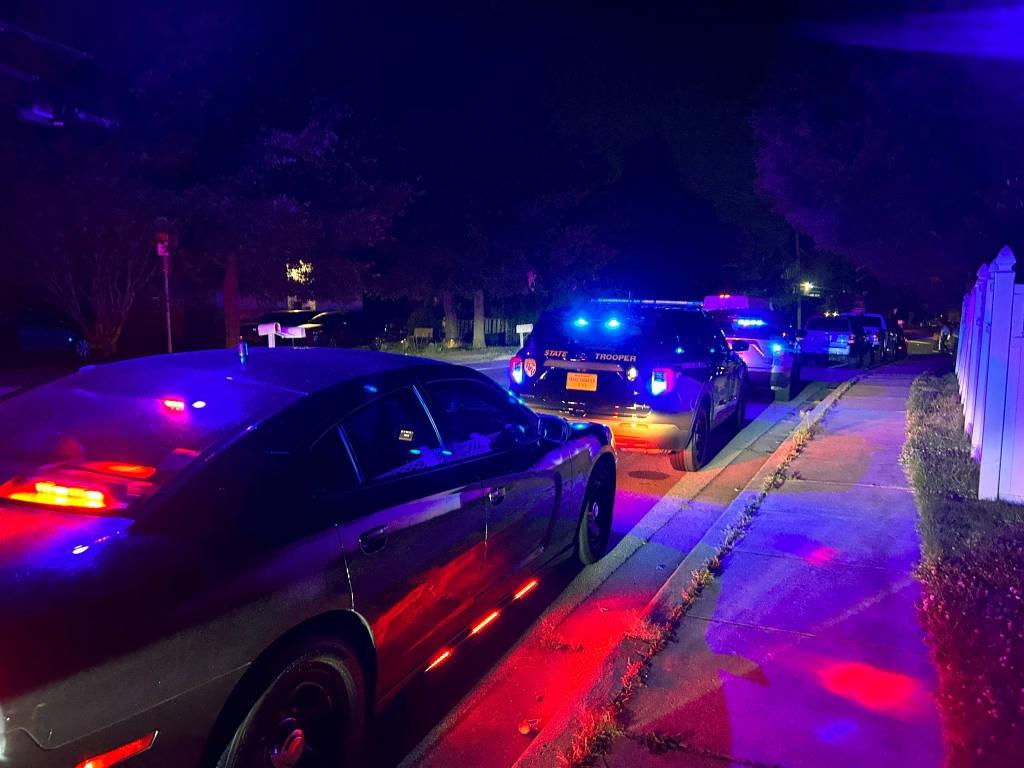 Police vehicles are seen on a residential street in Annapolis, Md., where six people were shot at a Paddington Place home on June 11, 2023. 