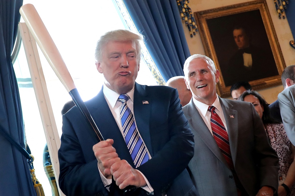 Vice President Mike Pence laughs as U.S. President Donald Trump holds a baseball bat as they attend a Made in America product showcase event at the White House in Washington, U.S., July 17, 2017.