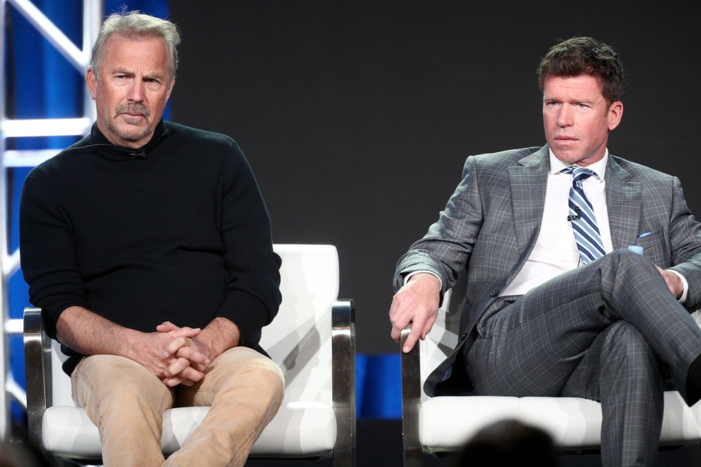 Kevin Costner with "Yellowstone" creator Taylor Sheridan sitting on a stage together. 