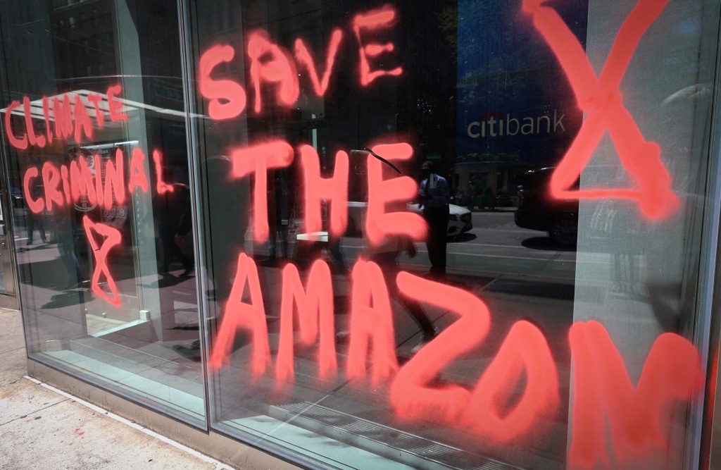 A message spray-painted by climate protestors is pictured on the outside of a Citibank branch in Midtown Manhattan in New York City.