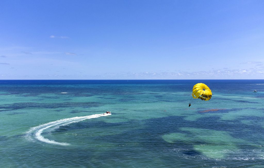 An aerial photo shows people participating watersports at a beach in Punta Cana, Dominican Republic.
