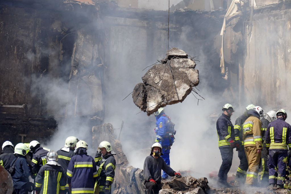 Rescuers are seen at work at the section of the block of flats destroyed in the Russian rocket attack on Uman, Cherkasy Region, central Ukraine, April 28, 2023. 