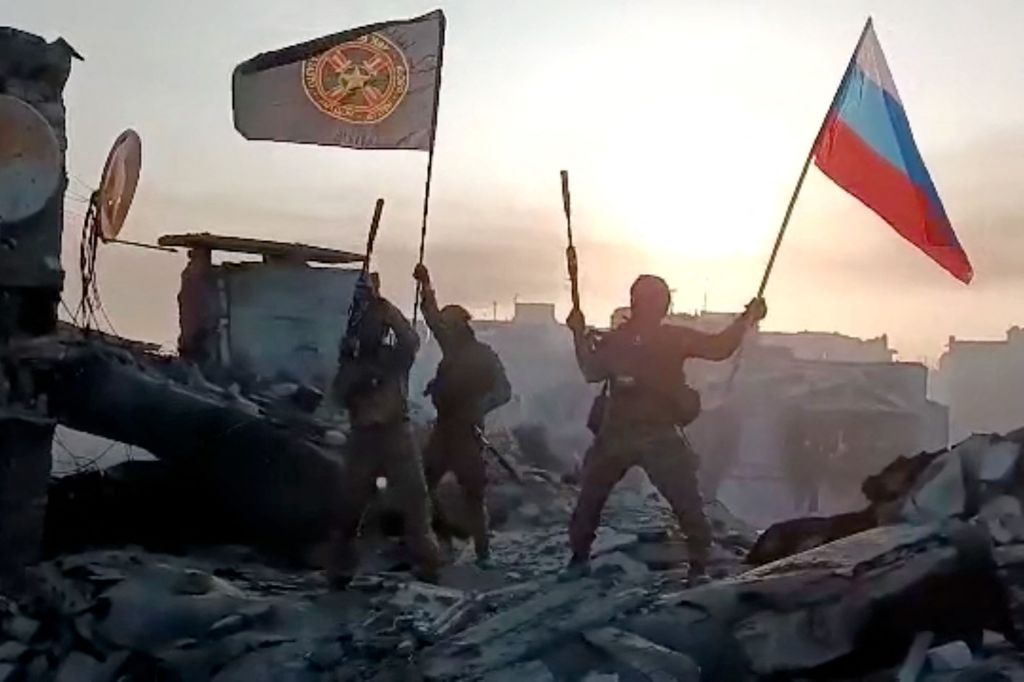 Members of the Wagner group were seen waving a Russian national flag and the Wagner Group's flag on the rooftop of a damaged building in Bakhmut, Ukraine.
