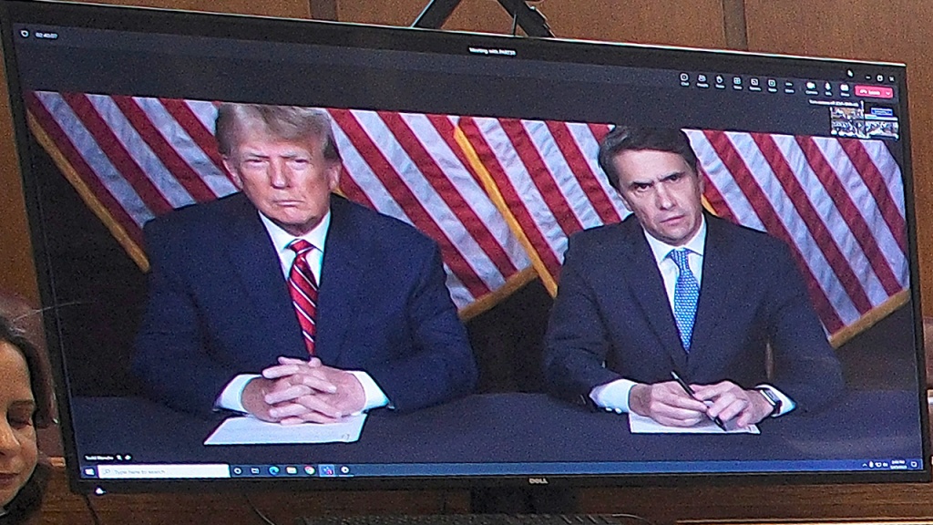 Donald Trump and his lawyer appearing by video in the criminal case.