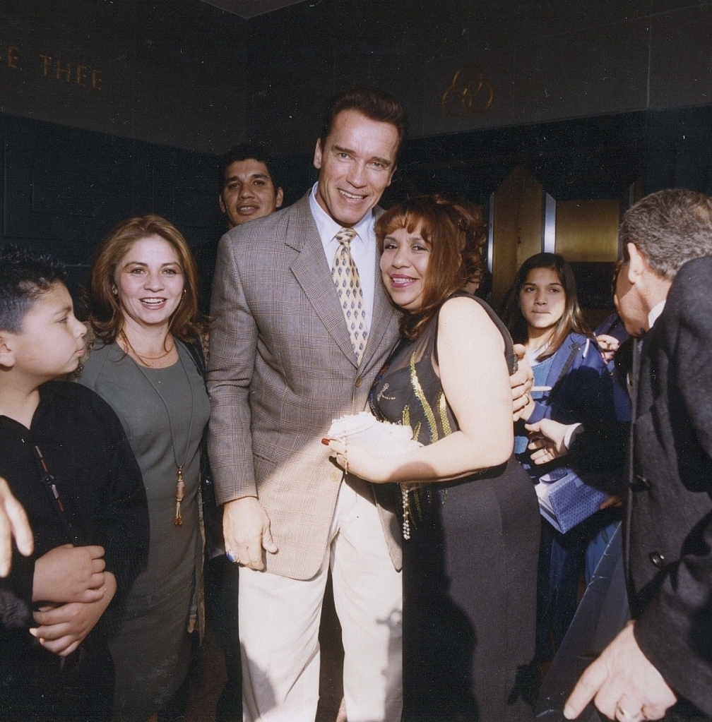 Arnold Schwarzenegger poses with Mildred Baena  in 2001.