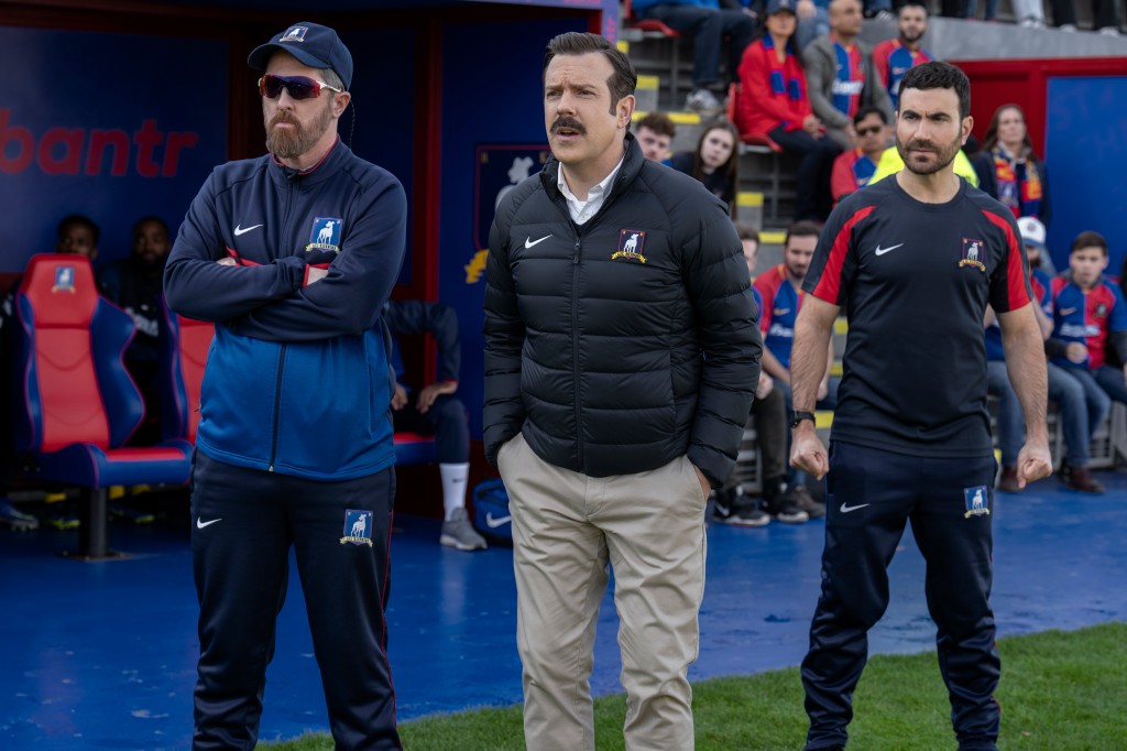 Ted Lasso (Jason Sudeikis, from left), Coach Beard (Brendan Hunt) and Roy Kent (Brett Goldstein) on the sideline.