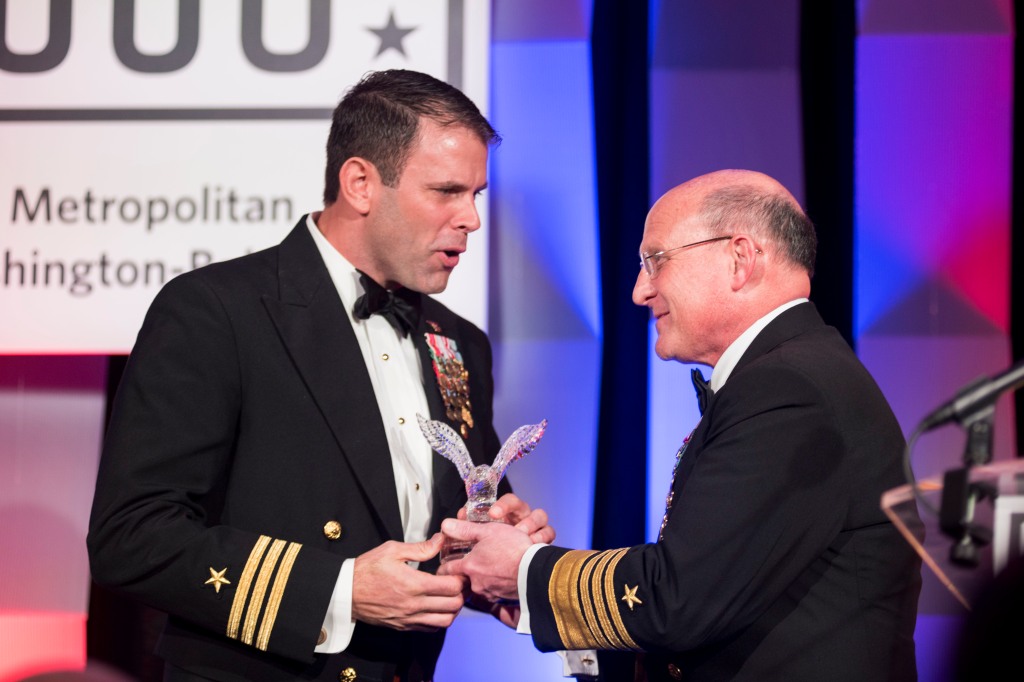 Chief of Naval Operations (CNO) Adm. Mike Gilday, right, presents Cmdr. Bradley Geary of Naval Special Warfare Command the USO Special Salute Award during the USO's 38th Annual Awards Dinner. 