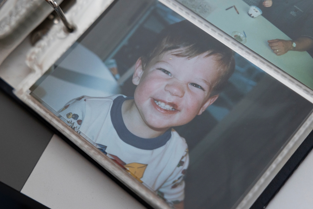 Photos of Kyle Mullen as a baby in his mother's photo albums.